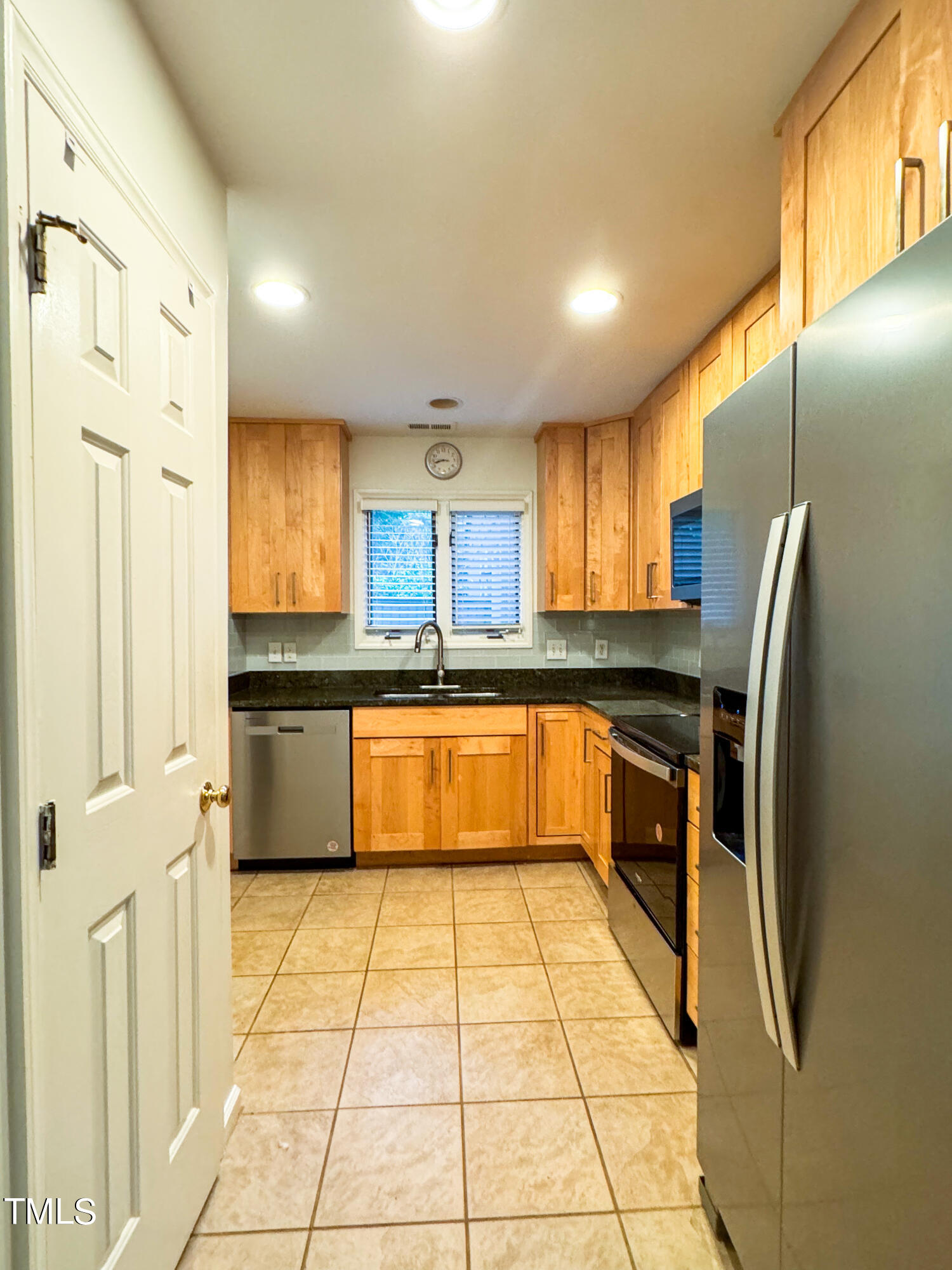4221 Sunscape Lane Raleigh, NC 27613 - Photo 4 of 29 a large kitchen with a large counter top stainless steel appliances and cabinets