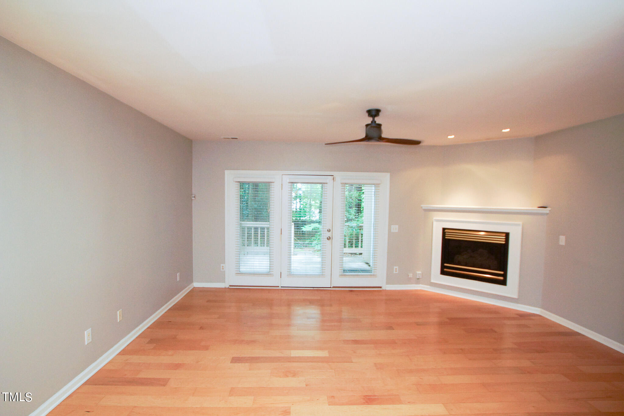 4221 Sunscape Lane Raleigh, NC 27613 - Photo 6 of 29 a view of an empty room with a fireplace and a window