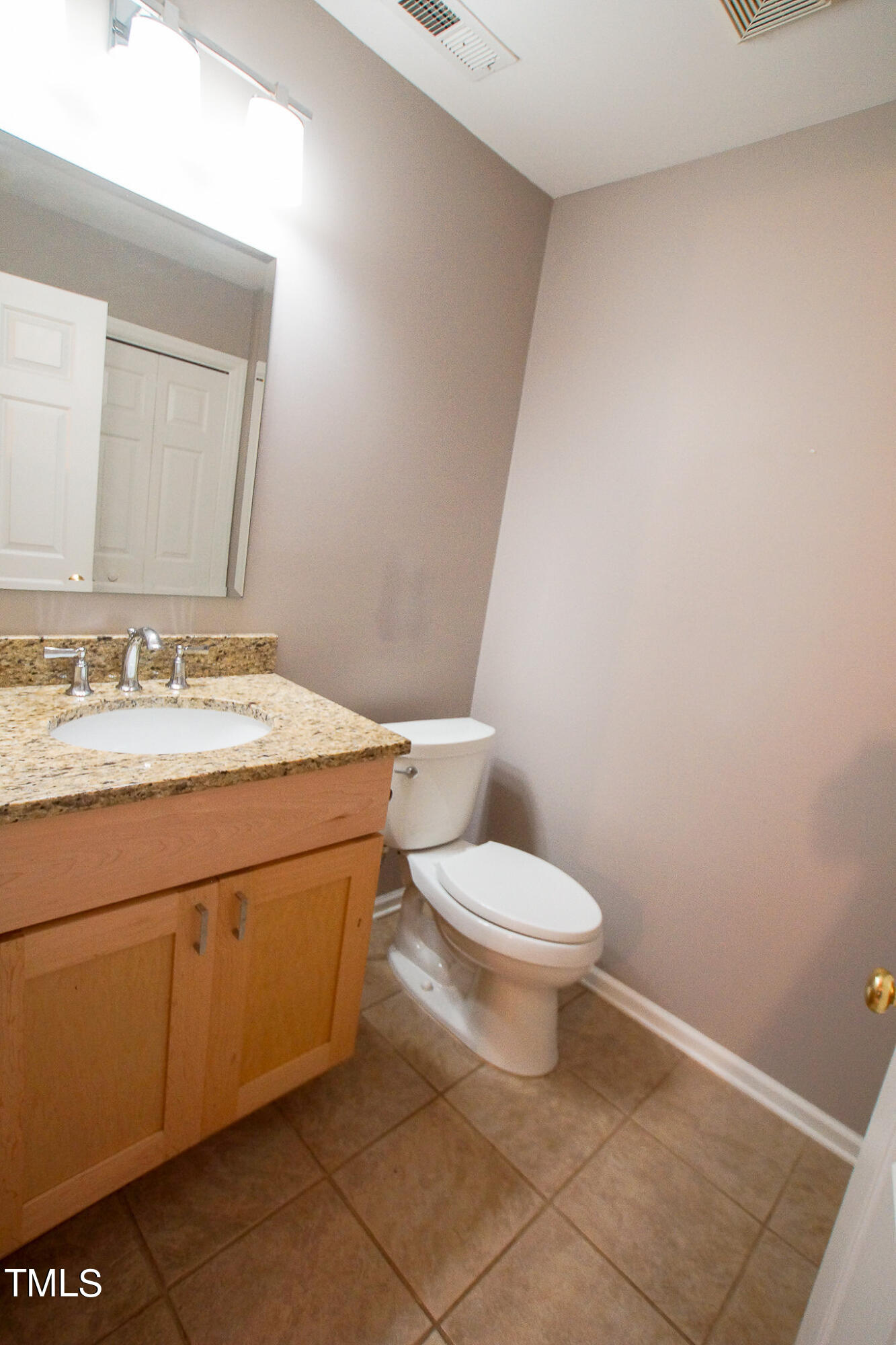 4221 Sunscape Lane Raleigh, NC 27613 - Photo 9 of 29 a bathroom with a granite countertop toilet and sink