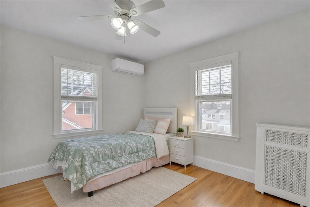 10 Dexter Road Lexington, MA 02420 - Photo 22 of 35 a bedroom with a large bed chandelier and a window