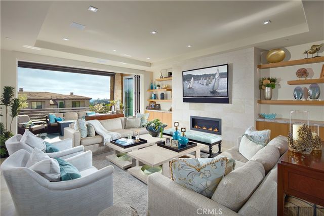 a living room with furniture and large windows