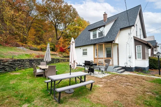 a backyard of a house with outdoor seating