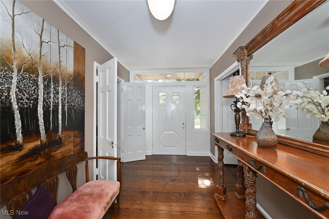 8960 Avery Road Broadview Heights, OH 44147 - Photo 19 of 50 Entryway featuring dark hardwood / wood-style flooring and crown molding w/rose colored brass halle lighting