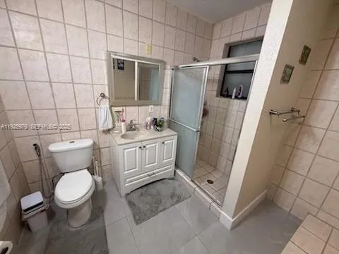 a white toilet sitting next to a bathroom sink