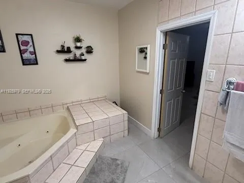 a bathroom with a bathtub and mirror