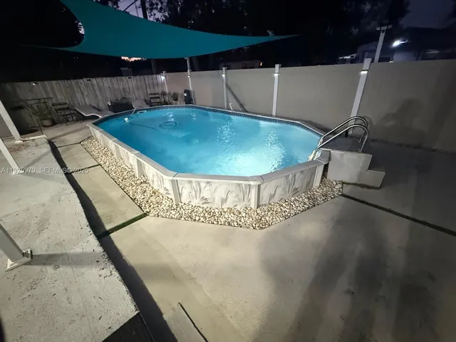 a room with pool table and chairs