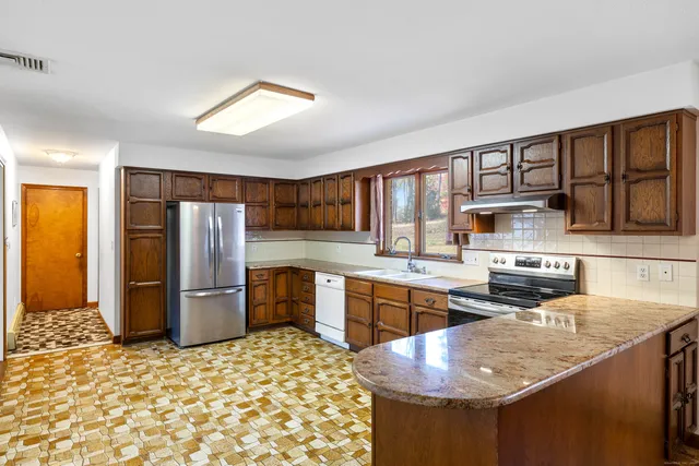 a kitchen with refrigerator and cabinets