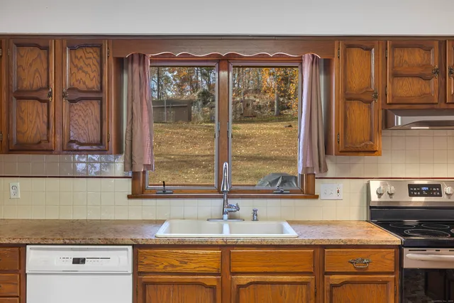 a kitchen with granite countertop a sink and a window