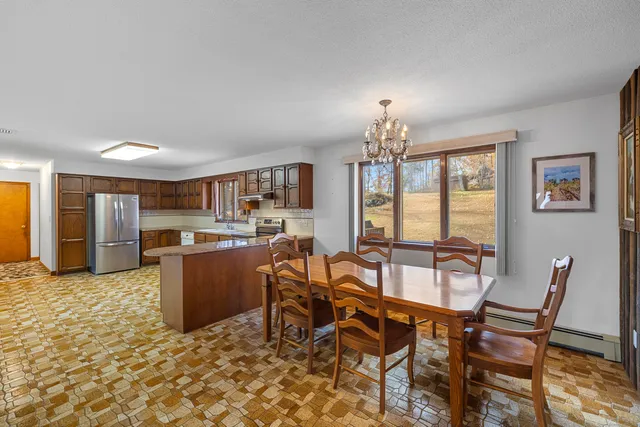 a view of a dining room with furniture and chandelier