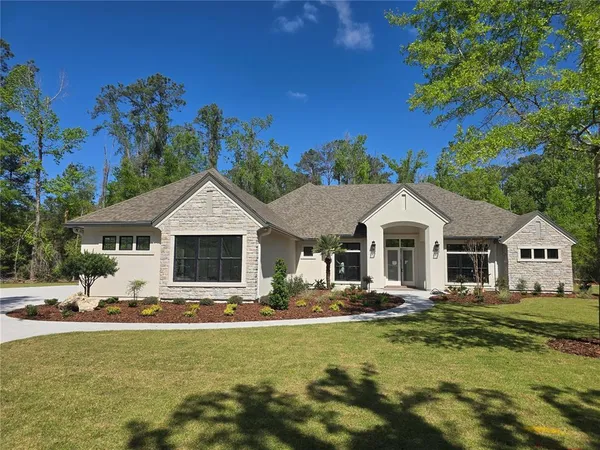 a front view of a house with swimming pool yard and outdoor seating