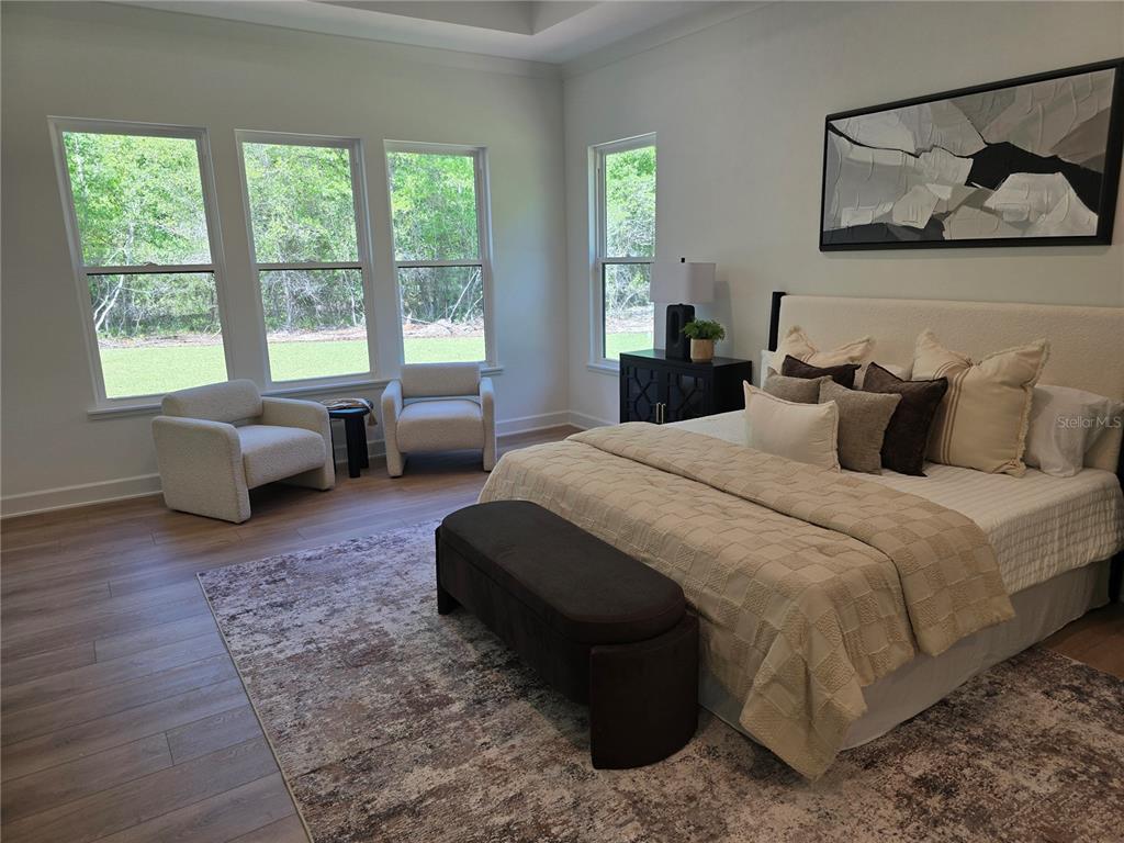 5990 Northwest 88th Street Gainesville, FL 32606 - Photo 8 of 11 a bedroom with a bed couch and a large window