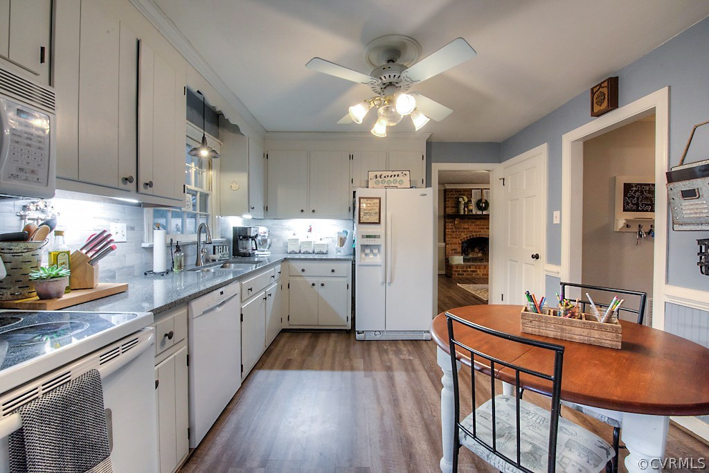 3919 Pebble Creek Road Midlothian, VA 23112 - Photo 12 of 46 a kitchen with stainless steel appliances granite countertop a refrigerator a sink dishwasher a stove dining table and chairs with wooden floor