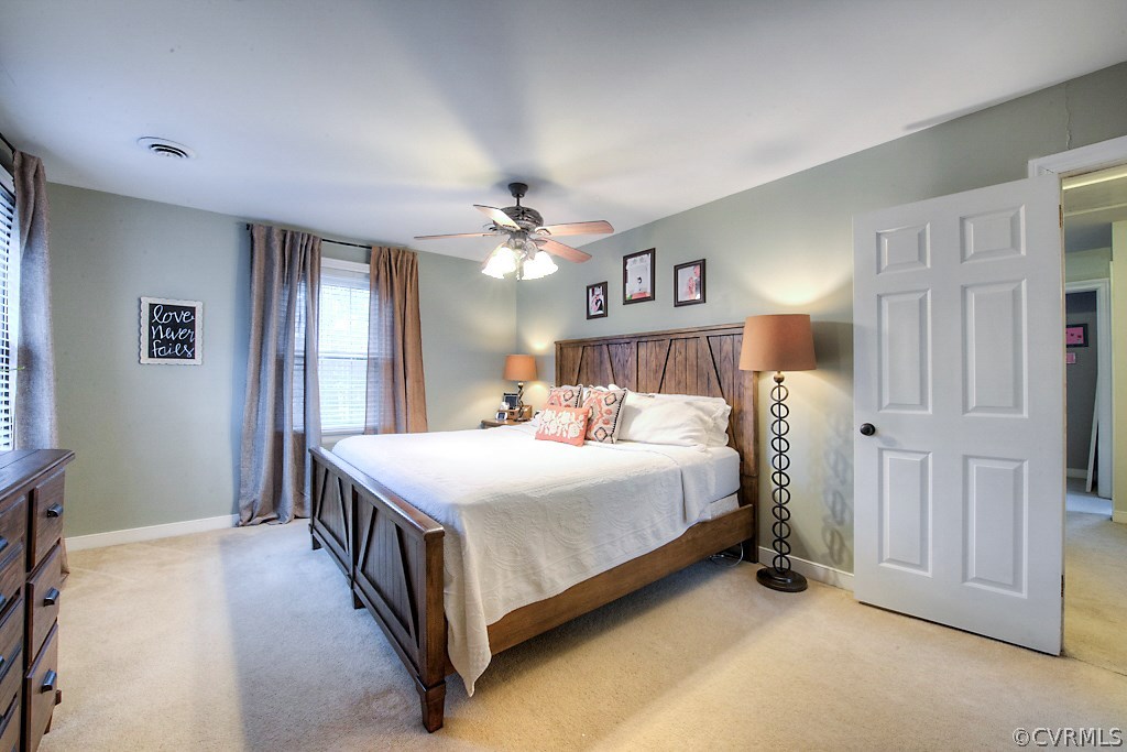 3919 Pebble Creek Road Midlothian, VA 23112 - Photo 32 of 46 a spacious bedroom with a bed and a chandelier