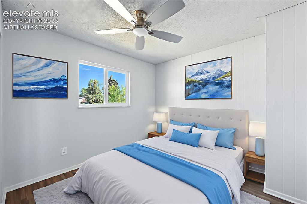 7033 Sequoyah Way Colorado Springs, CO 80915 - Photo 13 of 20 a bedroom with a bed and a painting on the wall