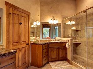 74 452nd Road, Unit COUNTY Breckenridge, CO 80424 - Photo 11 of 22 a bathroom with a granite countertop sink and a mirror