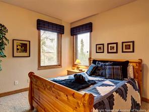 74 452nd Road, Unit COUNTY Breckenridge, CO 80424 - Photo 14 of 22 a bed sitting in a bedroom next to a window