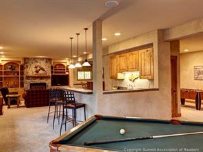 74 452nd Road, Unit COUNTY Breckenridge, CO 80424 - Photo 19 of 22 a room with lots of wooden furniture and windows