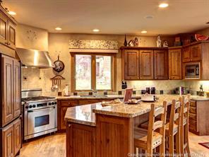 74 452nd Road, Unit COUNTY Breckenridge, CO 80424 - Photo 5 of 22 a kitchen with granite countertop a sink stove and cabinets