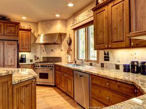 74 452nd Road, Unit COUNTY Breckenridge, CO 80424 - Photo 6 of 22 a kitchen with stainless steel appliances granite countertop a stove a sink dishwasher and a refrigerator