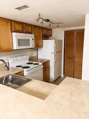 a kitchen with stainless steel appliances a refrigerator and a sink