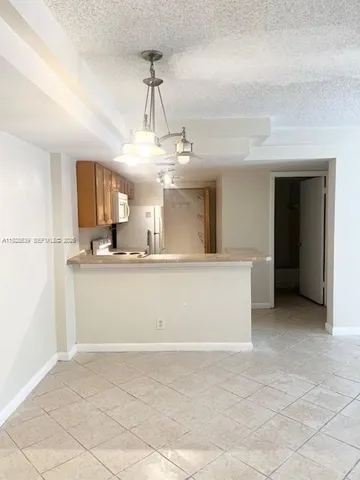 a view of a kitchen with stainless steel appliances granite countertop a sink and cabinets