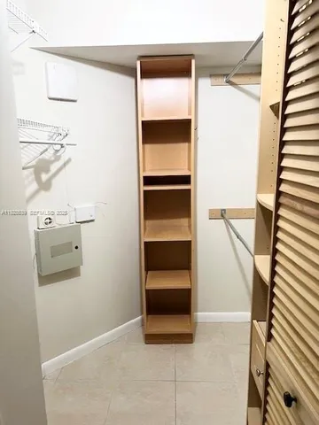 a view of walk in closet with empty racks