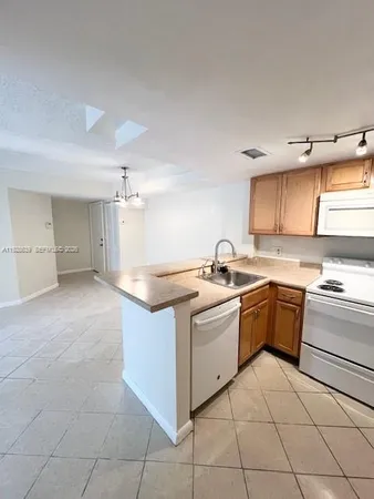a kitchen with a stove sink and cabinets