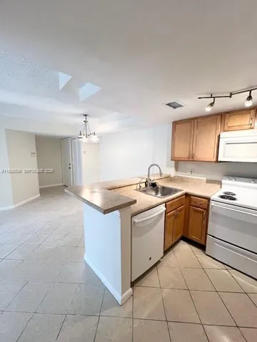 a kitchen with a stove sink and cabinets