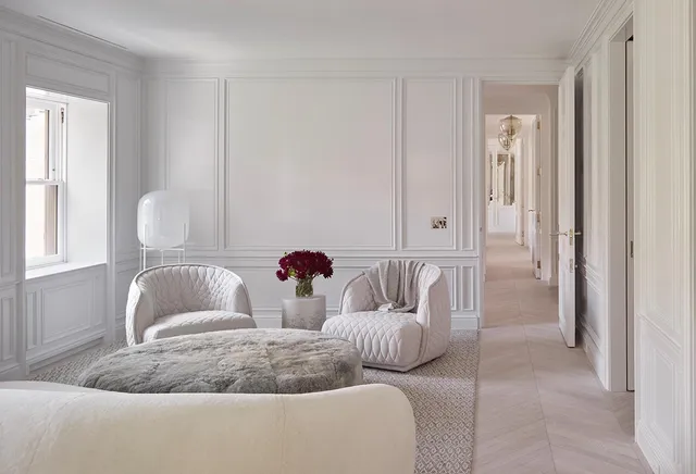 a view of a hallway with white walls and table