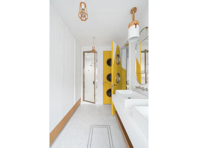 a bedroom with furniture and a large window