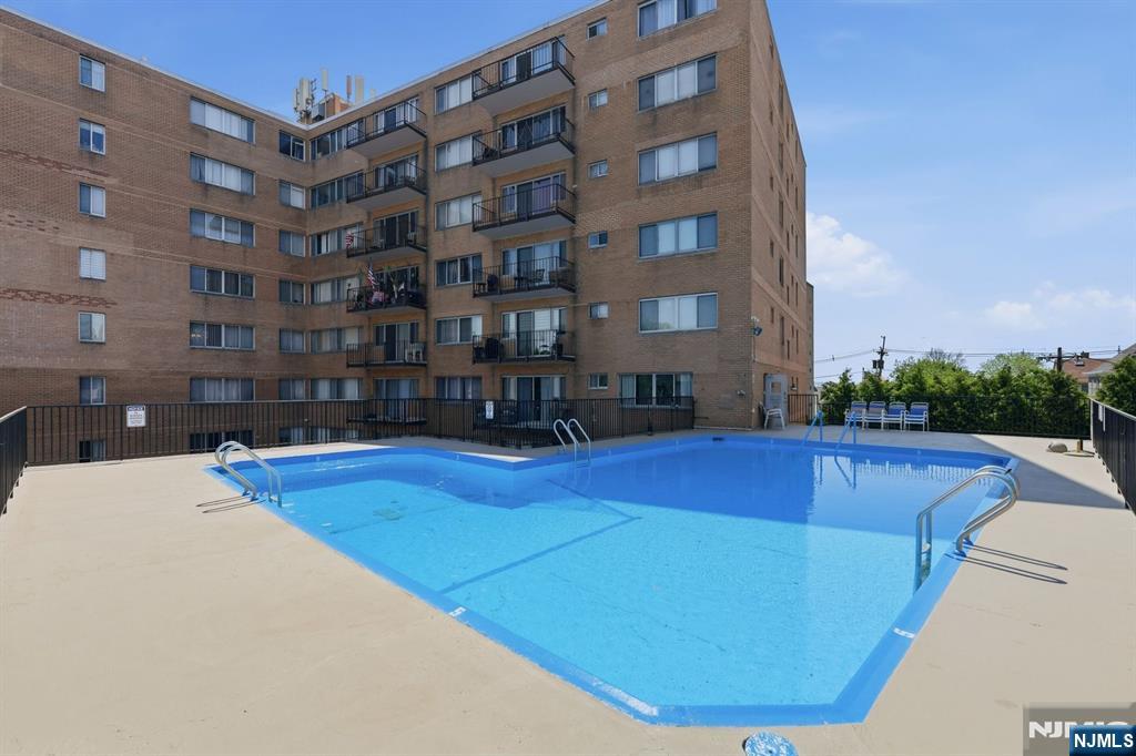 265 Main Street, Unit 704 Ridgefield Park, NJ 07660 - Photo 20 of 23 a view of a swimming pool with outdoor seating