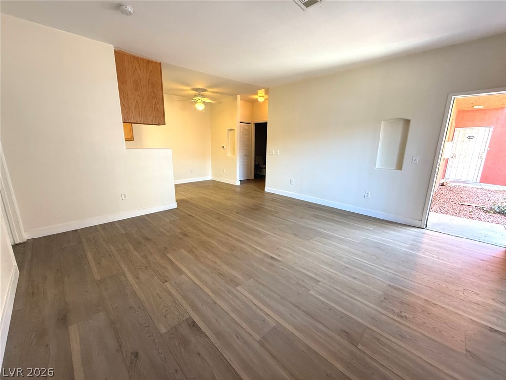 4730 East Craig Road, Unit 1164 Las Vegas, NV 89115 - Photo 2 of 14 Hardwood-style flooring extends through this airy living area, featuring an inviting entryway.