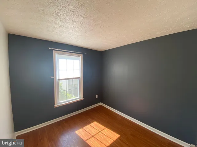 a view of balcony with wooden floor and fence