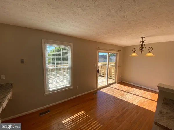a view of a room with wooden floor and windows