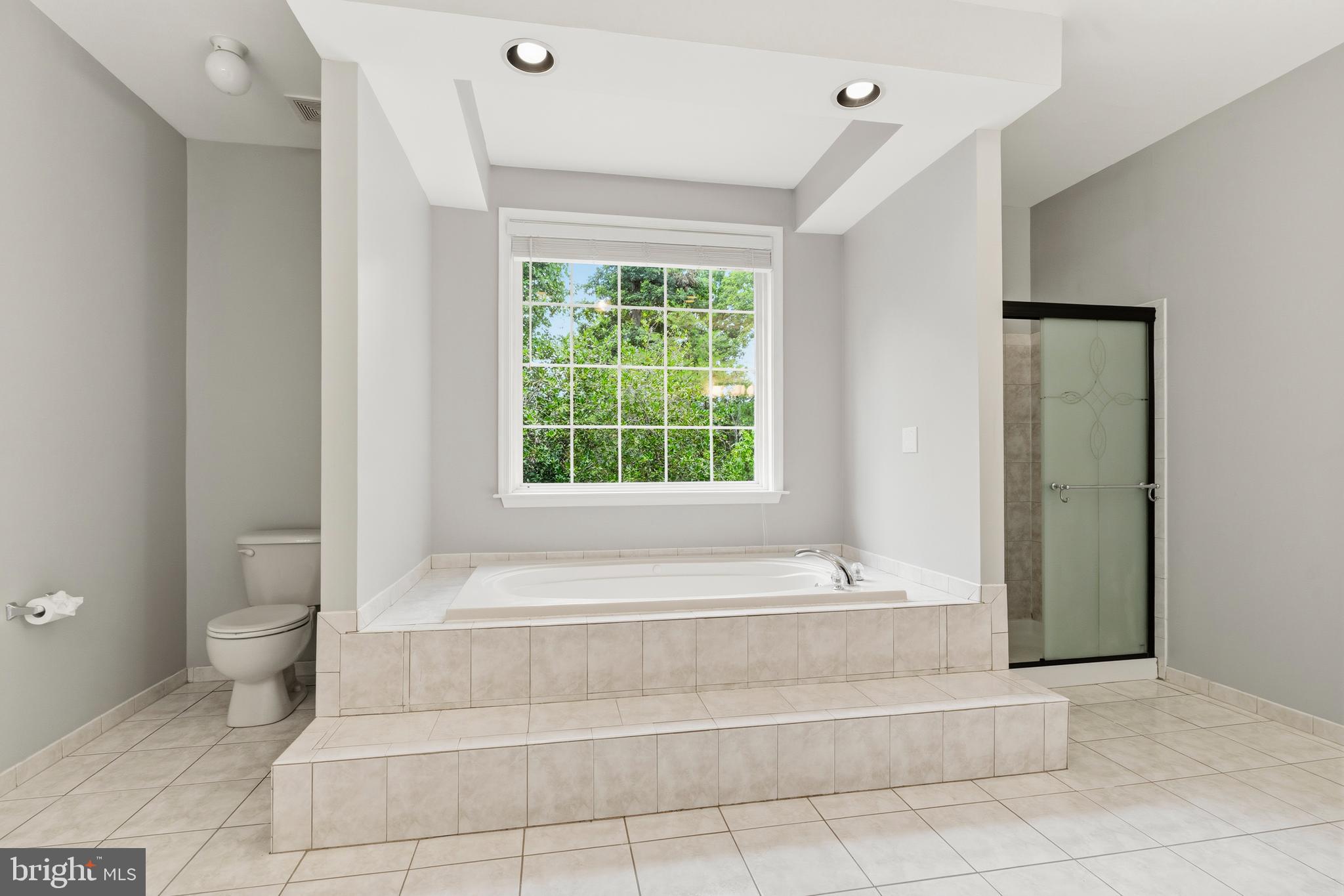 13305 Old Fort Road Fort Washington, MD 20744 - Photo 29 of 65 a bathroom with a bathtub and window