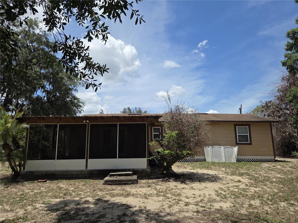 124 East F Street Frostproof, FL 33843 - Photo 34 of 37 a front view of a house with garden and patio