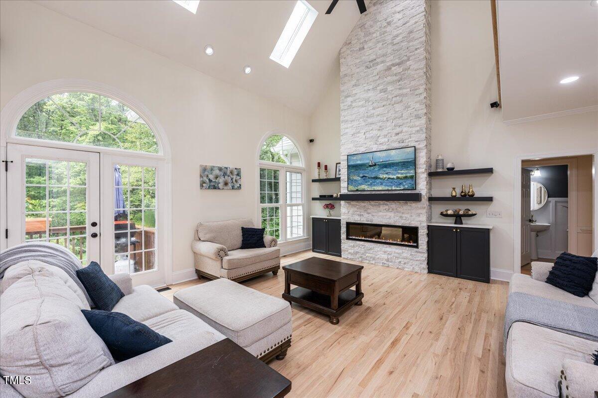 a living room with furniture fireplace and window