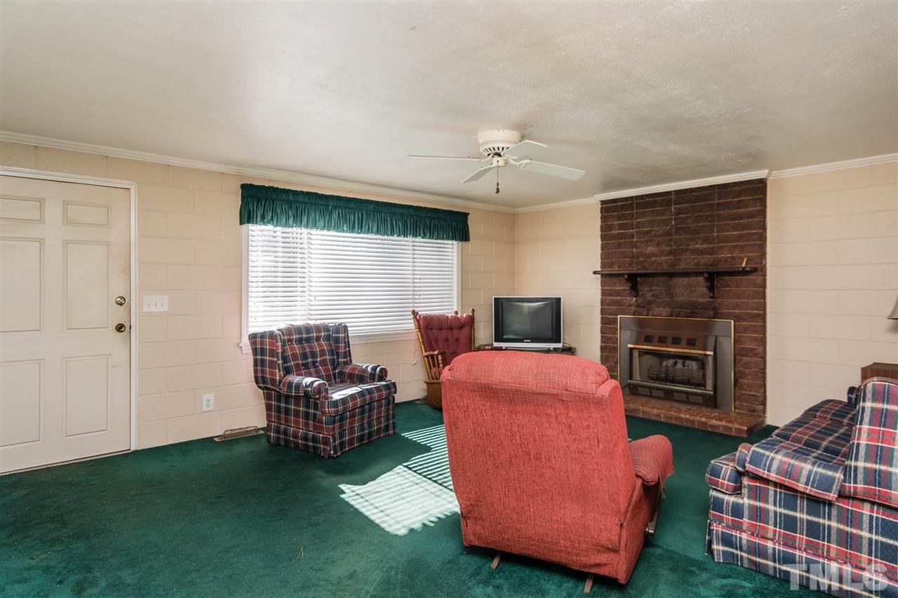1016 Legend Road Raleigh, NC 27603 - Photo 2 of 21 a living room with furniture and a fireplace
