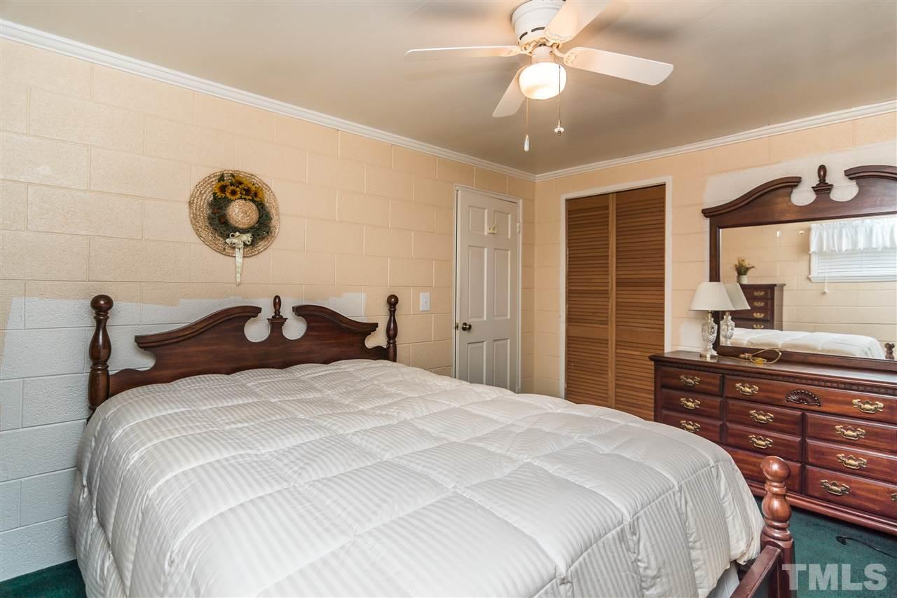 1016 Legend Road Raleigh, NC 27603 - Photo 14 of 21 a bedroom with a bed and a chandelier