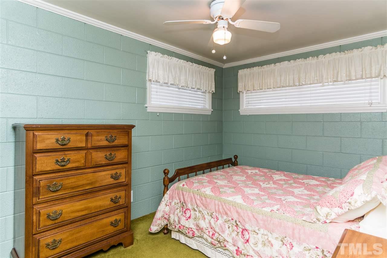 1016 Legend Road Raleigh, NC 27603 - Photo 15 of 21 a bedroom with a bed and a chandelier