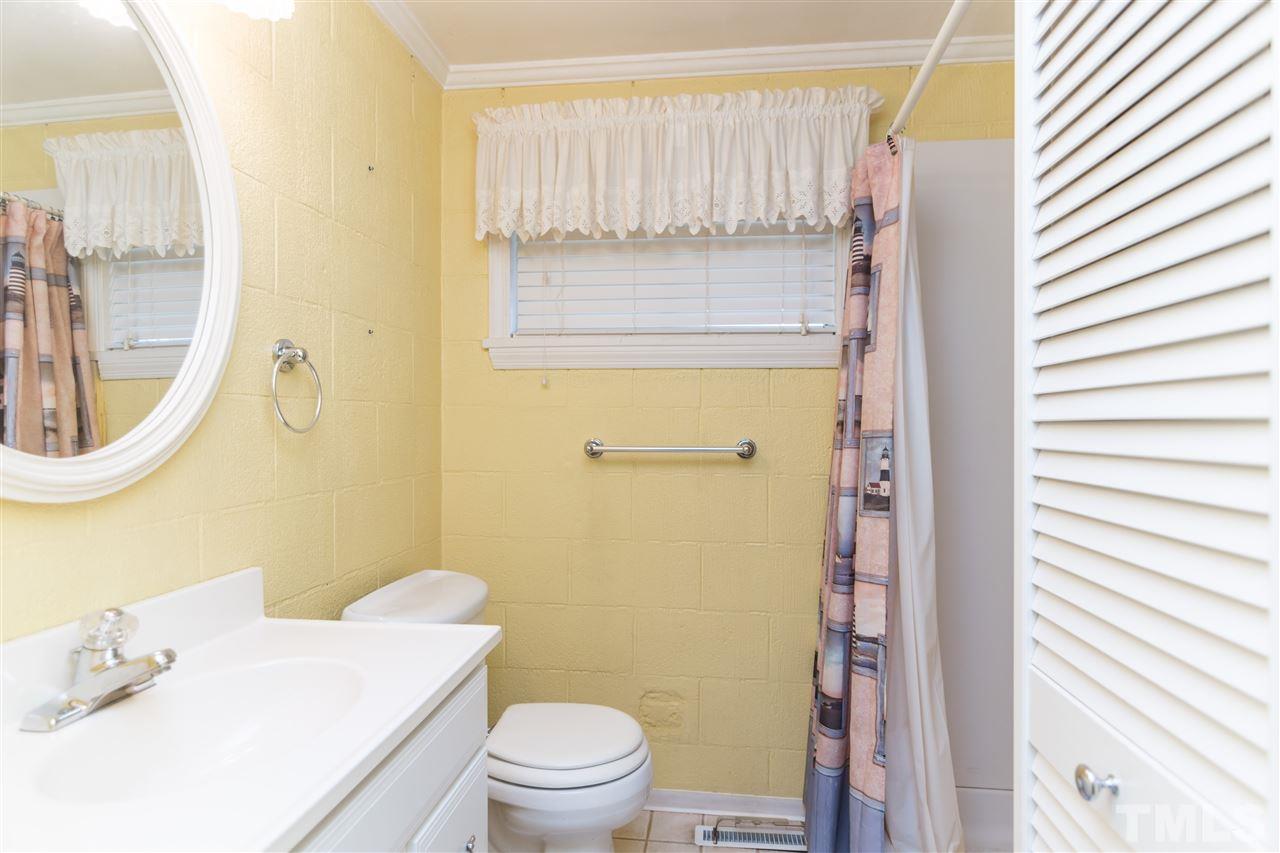 1016 Legend Road Raleigh, NC 27603 - Photo 17 of 21 a bathroom with a sink a toilet and shower curtain