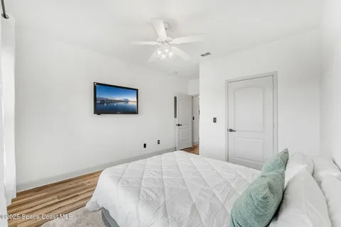 a bedroom with a bed and a tv