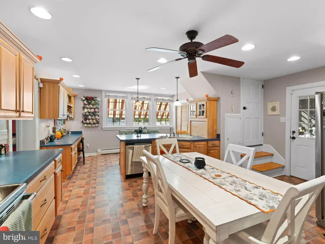 a large kitchen with a table and chairs
