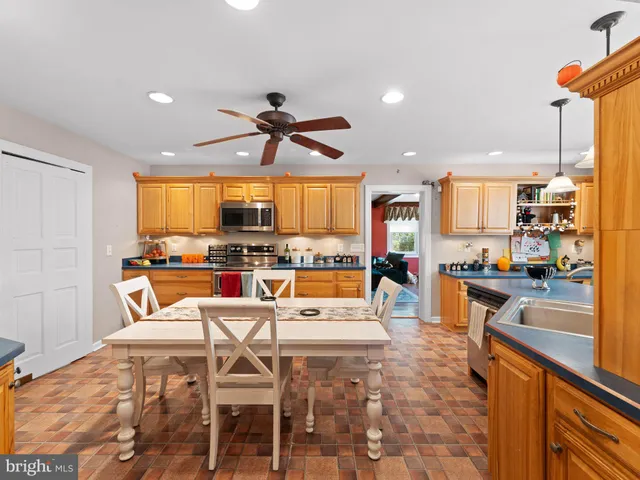 a large kitchen with a table and chairs in it