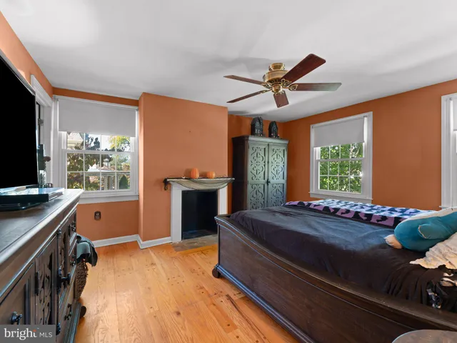 a living room with a bed furniture and a large window