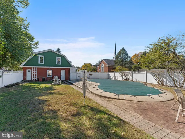 a view of a house with a yard and potted plants