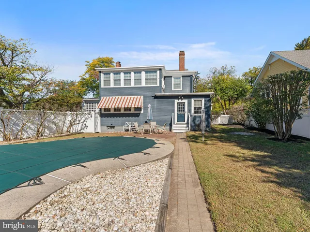 a front view of a house with a garden and yard