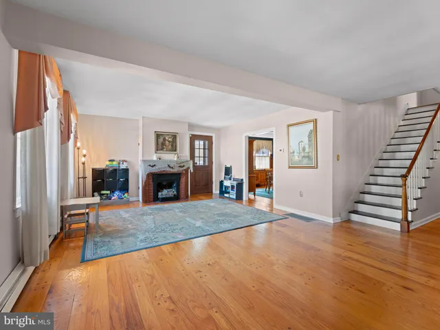 a view of a livingroom with wooden floor and fireplace