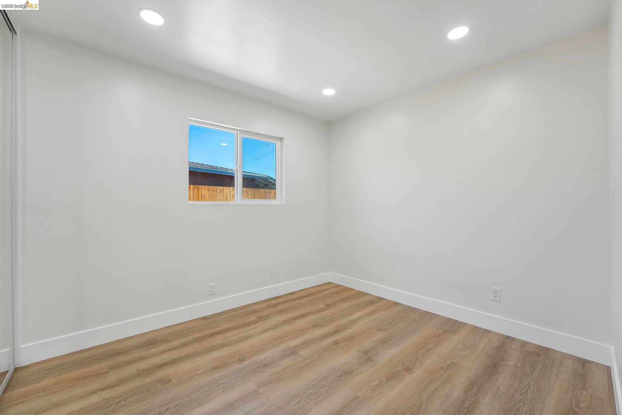 375 Senter Road San Jose, CA 95111 - Photo 33 of 80 an empty room with wooden floor and windows