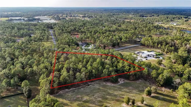 an aerial view of a houses with a yard